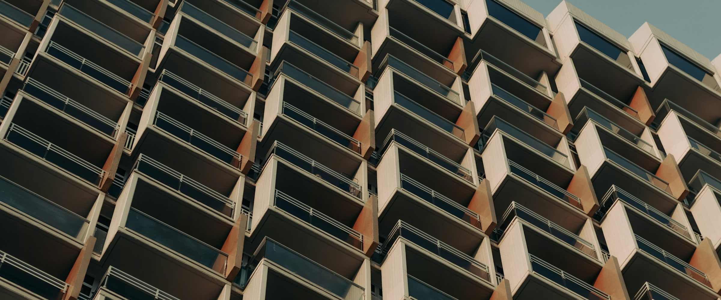 A tall residential tower: rows of windows from the base to the upper floors