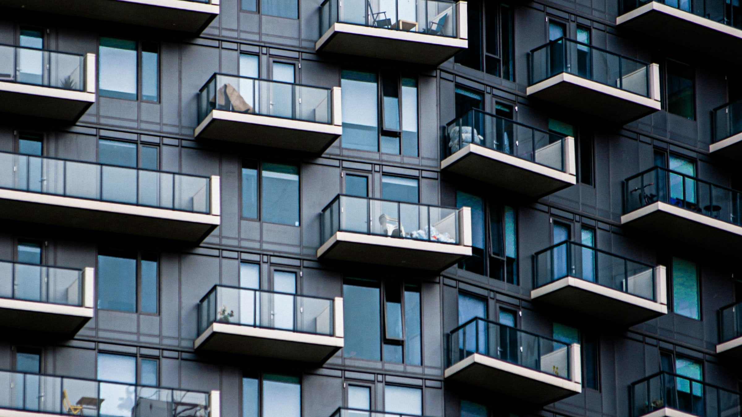 A residential block: rows of balconies and windows repeating floor after floor